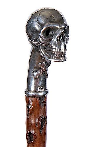 65. Silver Skull Rattle Cane- 20th Century- A cast and signed sterling handle of a high relief full figured skull and a pair 