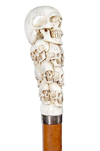 66. Stag Skull Cane- 20th Century- A high relief carved stag handle with approximately 13 skulls, the perfect number for a sk