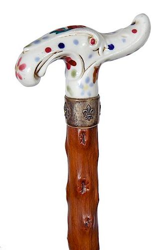 81. Porcelain Dress Cane- Ca. 1890- An art nouveau porcelain handle, an ornate silver metal collar, umbrella shaft and no fer