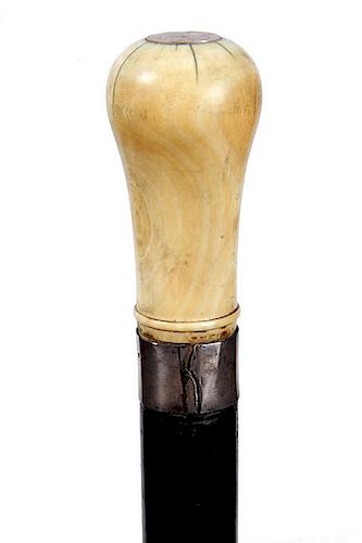 97. Nautical Dress Cane- Ca. 1850- Large whale tooth handle with an abalone disc atop, split silver collar, thick ebony shaft