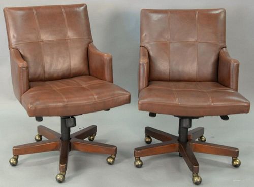 Pair of Councill leather swivel office armchairs.