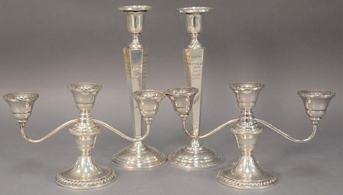 Four piece lot to include a pair of sterling silver weighted candelabra (lg. 9 3/4in.) and candlesticks (ht. 10in.).