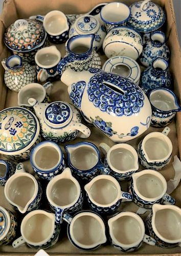 Tray lot of miniature handmade Polish pottery pieces including mugs, creamers, piggy bank, sugars, covered jars, etc. hand pa