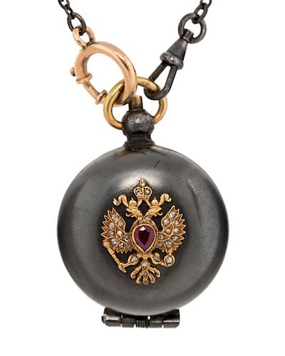 EARLY 20TH CENTURY RUSSIAN GOLD AND GUNMETAL COIN HOLDER LOCKET ON A CHAIN