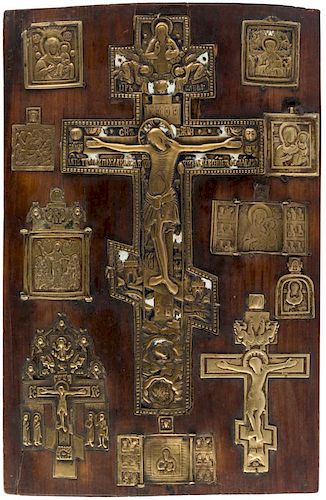 A PLAQUE OF MOUNTED BRASS ICONS, 18TH-19TH CENTURY