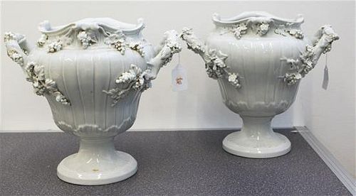* A Pair of Continental Blanc de Chine Porcelain Urns Height 10 inches.