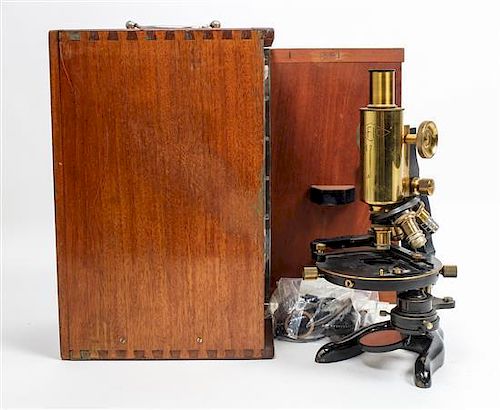 * A French Brass and Ebonized Steel Microscope, Soci-t- Fran-aise d'Instruments Optiques Height 12 1/4 inches.