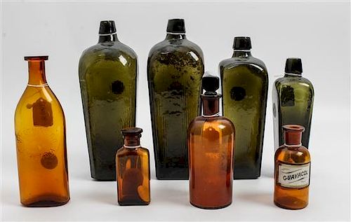 A Collection of Eight Glass Bottles Height of tallest 11 inches.