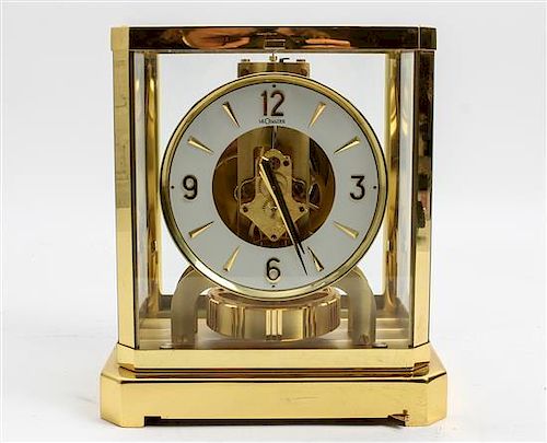 A LeCoultre Brass and Glass Atmos Clock Height 9 1/8 x width 8 1/4 x depth 6 1/4 inches.