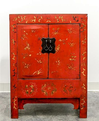 * A Chinese Red Lacquered Elmwood Cabinet