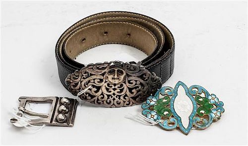 A Mexican Silver Belt Buckle, La Cucaracha, Taxco, together with a belt with a silvered metal buckle and a gilt-metal and ena