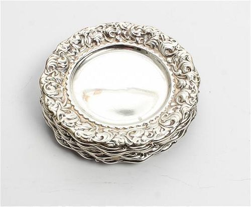 A Set of Eight American Silver Butter Dishes, Whiting Mfg. Co., New York, NY, each with repousee foliate decorated borders.
