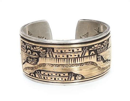 A Navajo Silver and 14 Karat Gold Pictorial Bracelet Length 5 3/4 x opening 3/4 x width 1 1/4 inches.