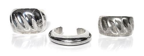 Three Navajo Holloware Silver Cuffs, Orville Tsinnie (1943-2017) Length of one 5 1/2 x opening 7/8 x width 1 7/8 inches.