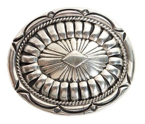 A Navajo Stamped Silver Belt Buckle, Orville Tsinnie (1943-2017) Height 2 5/8 x width 3 1/4 inches.