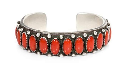 A Navajo Silver and Coral Cuff Bracelet, Calvin Martinez (b. 1960) Length 5 1/2 x opening 7/8 x width 5/8 inches.