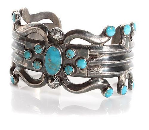 A Navajo Silver and Turquoise Cuff Bracelet Length 5 3/8 x opening 1 1/8 x width 1 1/4 inches.