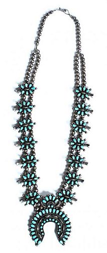 A Southwestern Silver and Turquoise Squash Blossom Necklace Length 27 1/4 inches.
