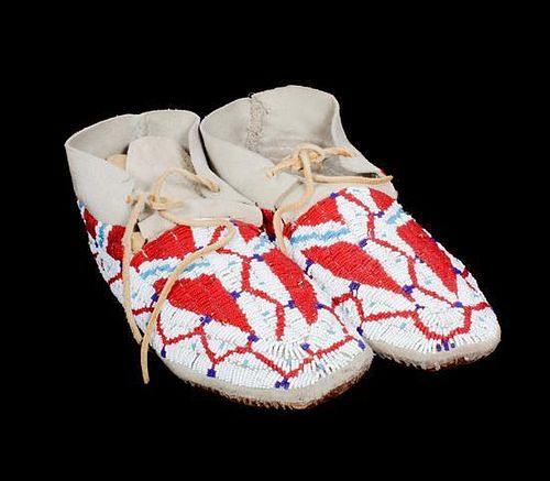 A Pair of Crow Beaded Moccasins Length of larger 10 1/2 inches.