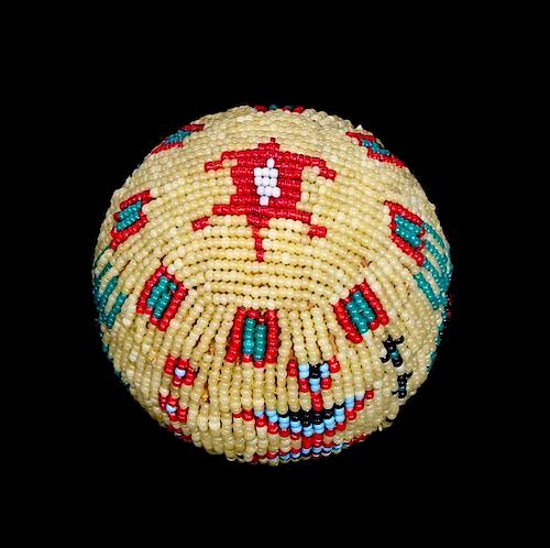 A Sioux Beaded Hide Ball Circumference 9 inches.
