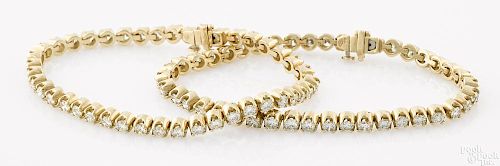 Two 14K yellow gold and diamond tennis bracelets