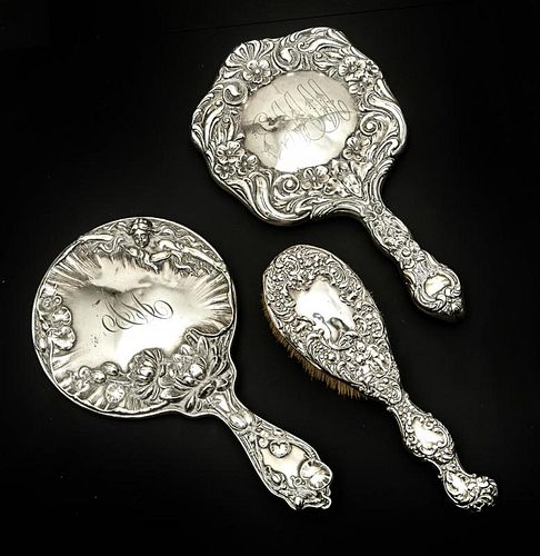 2 Sterling repousse hand mirrors and brush