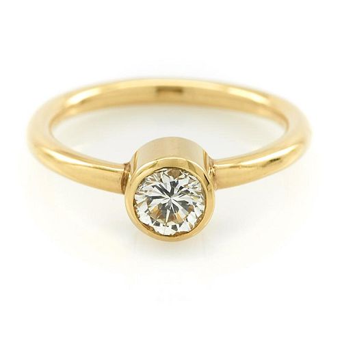 14k Yellow gold and bezel set diamond ring.
