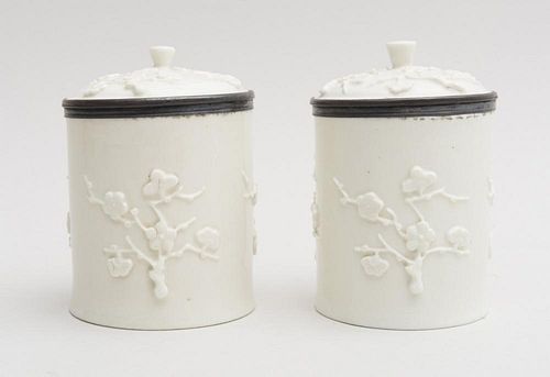 PAIR OF FRENCH RELIEF-DECORATED PORCELAIN TOBACCO JARS AND COVERS