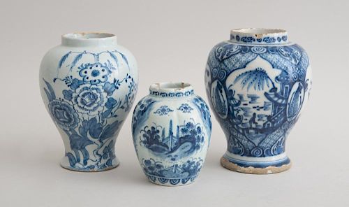 TWO BLUE AND WHITE DELFT BALUSTER-FORM JARS AND A FLUTED OVOID JAR