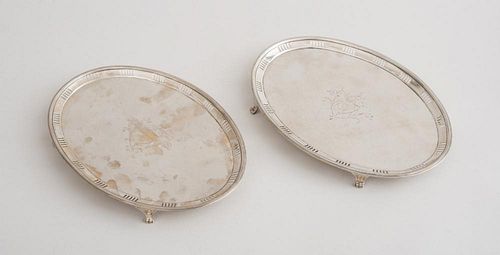 PAIR OF IRISH GEORGE III CRESTED SILVER OVAL WAITERS
