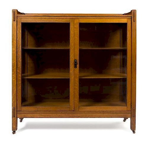 * Arts and Crafts, FIRST HALF 20TH CENTURY, bookcase, having three-quarter galleried top over two glazed doors