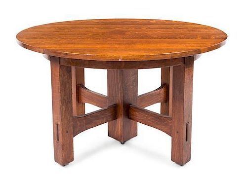* Gustav Stickley, (American, 1858-1942), an oak extension table, model no. 634, having a circular top expanding to oval, rai