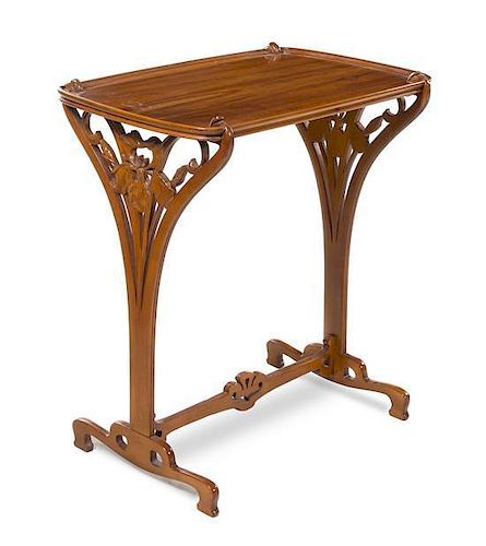 * French, FIRST HALF 20TH CENTURY, an Art Nouveau style carved mahogany occasional table