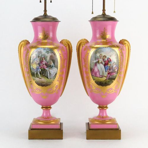 Pair of Antique Sevres Style Porcelain Urn Lamps. Gilt hand painted scrolling on rose ground with mock figural handles, court