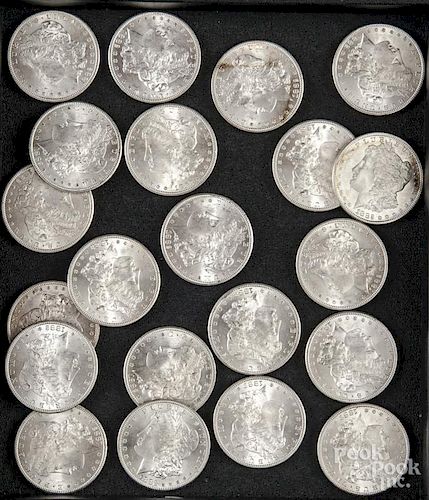 Twenty-one Morgan silver dollars
