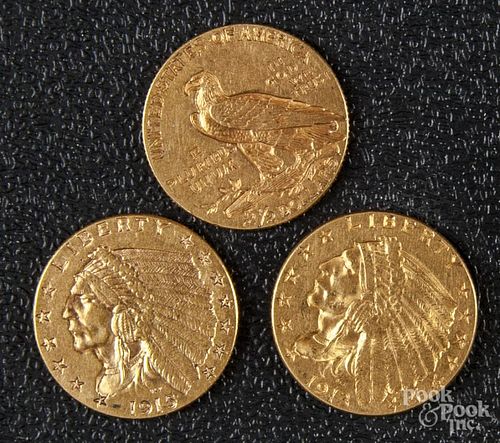 Three US two and a half dollar gold coins.