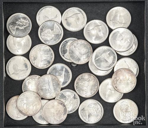 Twenty-nine Canadian pre-1967 silver dollars.