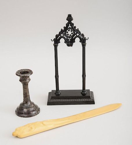 GOTHIC REVIVAL CAST-METAL DOUBLE ARCH STAND, A CROCODILE MARBLE CANDLESTICK AND A FAUX IVORY PAGE CUTTER WITH CROCODILE HANDL