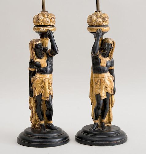 PAIR OF CONTINENTAL CARVED, BLACK-PAINTED AND PARCEL-GILT FIGURES OF ANCIENT EGYPTIAN SERVANTS, MOUNTED AS LAMPS