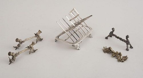 VICTORIAN SILVER SIX-PIECE TOAST RACK AND FOUR CAST METAL CUTLERY RESTS