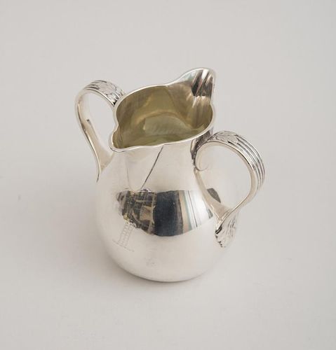 VICTORIAN CRESTED AND INSCRIBED SILVER DOUBLE-SPOUTED CREAM JUG