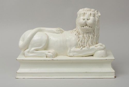 LARGE WHITE GLAZED FIGURE OF A RECUMBENT LION