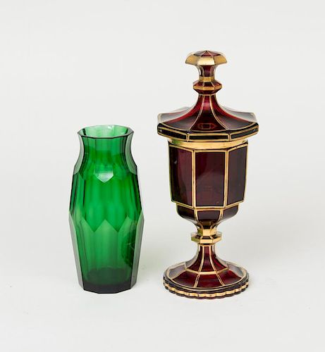 MOSER STYLE GREEN FACETED GLASS VASE AND A FACETED GILT RED GLASS CUP AND COVER