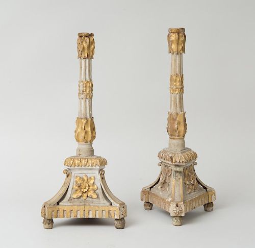PAIR OF CARVED PAINTED AND PARCEL GILT CANDLESTICKS, POSSIBLY PORTUGUESE