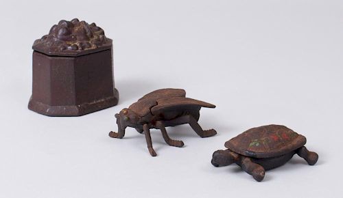 THREE CAST-IRON BOXES IN THE FORM OF A TURTLE, A FLY, AND A HEXAGONAL WITH LION HEAD COVER