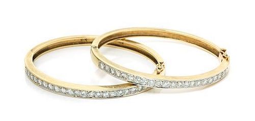 A Pair of Platinum Topped 18 Karat Yellow Gold and Diamond Bangle Bracelets, 29.40 dwts.