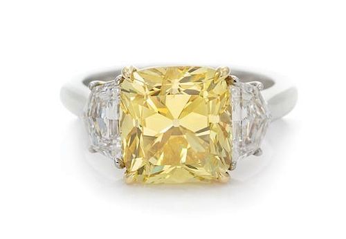 A Platinum, 18 Karat Yellow Gold, Fancy Vivid Yellow Diamond and Diamond Ring, 5.40 dwts.