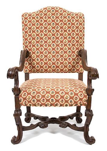 A Baroque Style Carved Walnut Open Armchair Height 48 x width 30 x depth 28 inches.