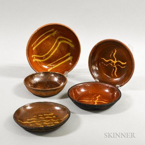 Five Redware Pottery Dishes, four with slip decoration, dia. to 8 3/4 in.