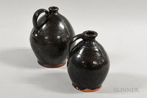 Two Black-glazed Redware Ovoid Jugs, possibly Maine, ht. to 8 in.